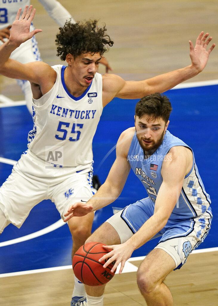 Tony Dejak North Carolina's Andrew Platek (3) drives against Kentucky's Lance Ware (55) in the first half of an NCAA college basketball game, Saturday, Dec. 19, 2020, in Cleveland. (AP Photo/Tony Dejak)