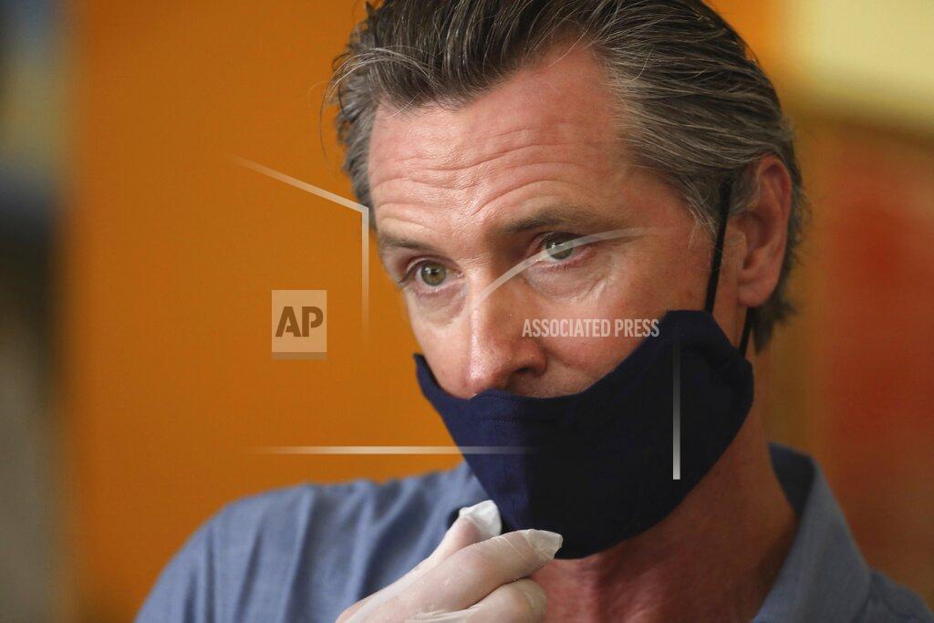 Genaro Molina California Gov. Gavin Newsom is interviewed while visiting the Hot and Cool Cafe in Leimert Park in Los Angeles on Wednesday, June 3, 2020. (Genaro Molina/Los Angeles Times via AP, Pool)