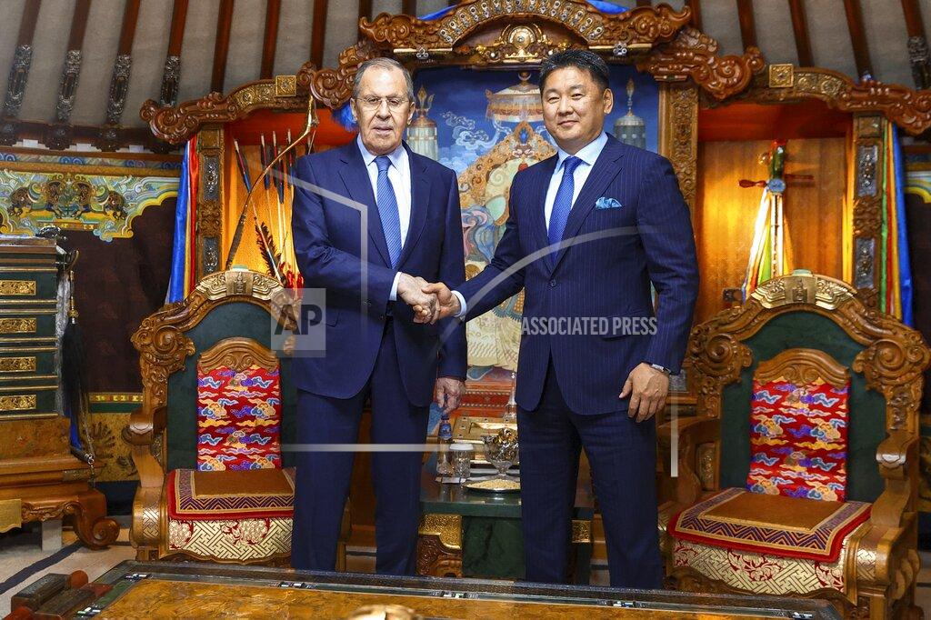 Uncredited In this photo released by Russian Foreign Ministry Press Service, Mongolian President Ukhnaagiin Khurelsukh, right, and Russian Foreign Minister Sergey Lavrov shake hands during their meeting in Ulaanbaatar, Mongolia, Tuesday, July 5, 2022. (Russian Foreign Ministry Press Service via AP)