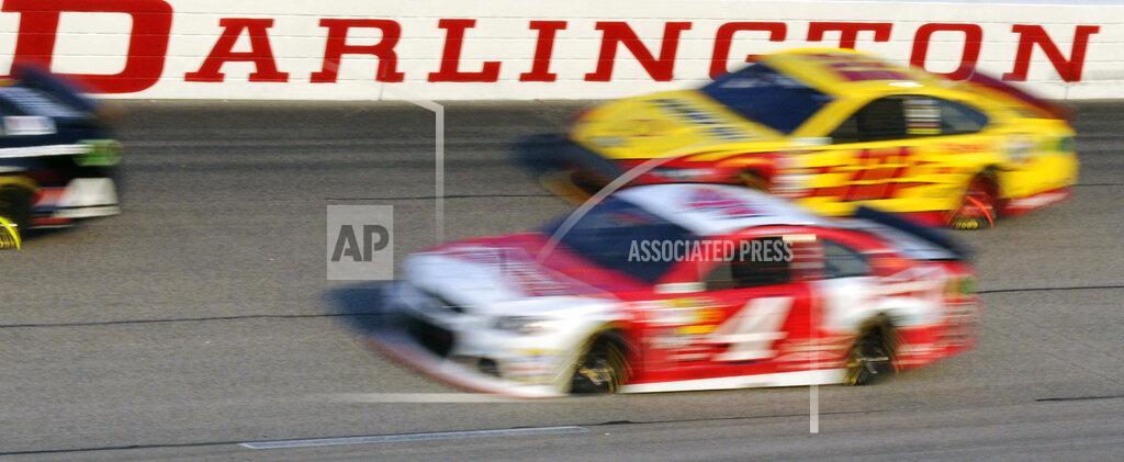 Mike Mccarn FILE - In this April 12, 2014, file photo, Kevin Harvick (4) and Joey Logano (22) race during a NASCAR Sprint Cup series auto race at Darlington Raceway in Darlington, S.C. NASCAR will get its season back on track starting May 17 at Darlington Raceway in South Carolina without spectators, and the premier Cup Series plans to race four times in 10 days at a pair of iconic tracks. The revised schedule released Thursday, April 30, 2020, goes only through May and has a pair of Wednesday races — fulfilling fans longtime plea for midweek events. (AP Photo/Mike McCarn, File)