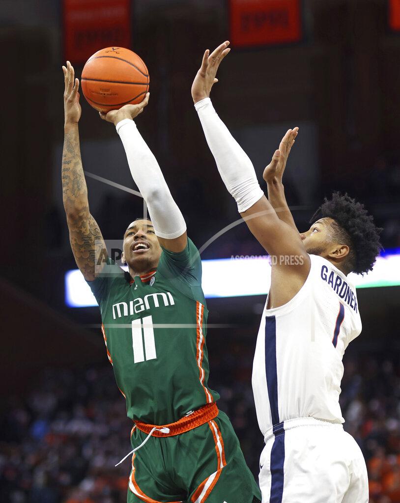 Andrew Shurtleff Miami guard Jordan Miller (11) shoots next to Virginia forward Jayden Gardner (1) during an NCAA college basketball game in Charlottesville, Va., Saturday, Feb. 5, 2022. (AP Photo/Andrew Shurtleff)