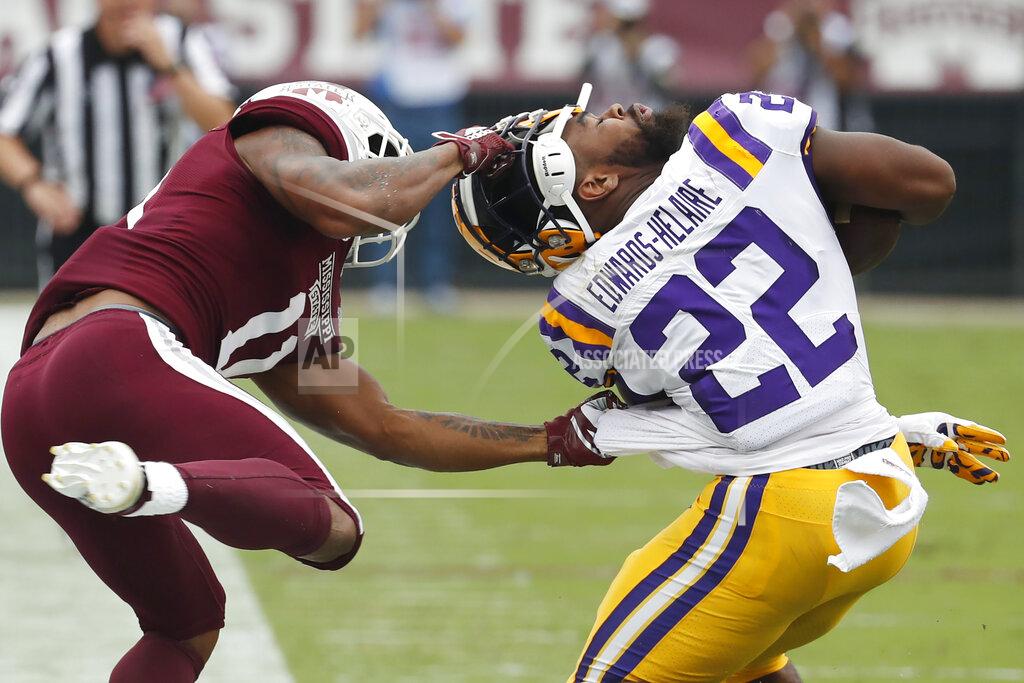 Rogelio V. Solis Mississippi State safety Jaquarius Landrews (11) pulls the helmet off LSU running back Clyde Edwards-Helaire (22) during the first half of their NCAA college football game in Starkville, Miss., Saturday, Oct. 19, 2019. Landrews was flagged for a personal foul. (AP Photo/Rogelio V. Solis)