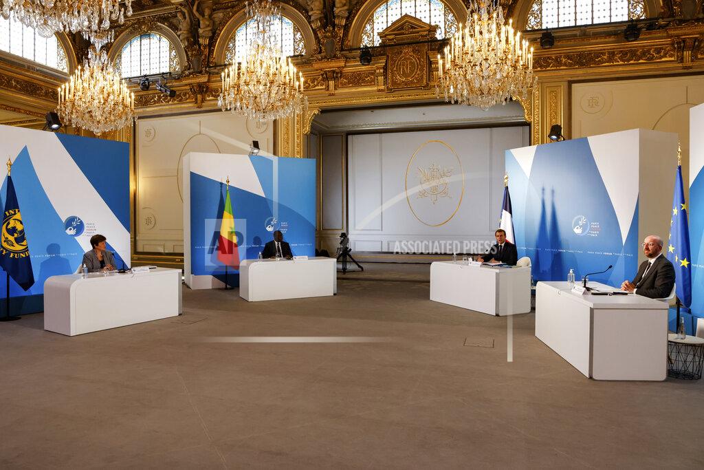 Ludovic Marin French President Emmanuel Macron, second right, European Council President Charles Michel, right, Senegal's President Macky Sall, second left, and International Monetary Fund Managing Director Kristalina Georgieva attend The Paris Peace Forum at The Elysee Palace in Paris, Thursday, Nov. 12, 2020. (Ludovic Marin, Pool via AP)
