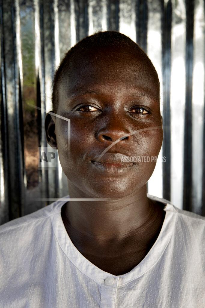 Adrienne Surprenant Paska Itwari Beda, the young mother of five children, is on the phone at her Juba, South Sudan home, Wednesday, May 26, 2021. Even before the pandemic hit, South Sudanese women were accustomed to building lives on the edge of uncertainty. But COVID-19 is shaking that fragile foundation. The country is just a decade old and one of the world's most difficult places to raise children. (AP Photo/Adrienne Surprenant)