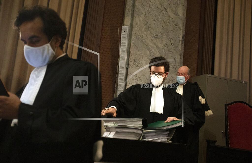 Virginia Mayo Lawyers for the European Commission from left, Rafael Jafferali , Charles Edouard Lambert and Alain Foriers carry documents as they arrive for a hearing, European Commission vs AstraZeneca, at the main courthouse in Brussels, Wednesday, May 26, 2021. While the EU insists AstraZeneca has breached its contractual obligations, the company says it has fully complied with the agreement, arguing that vaccines are difficult to manufacture and it made its best effort to deliver on time. the European Union's executive branch will try to persuade a Brussels court Wednesday that the case is urgent enough to justify ordering the company to make an immediate delivery of the missing shots. (AP Photo/Virginia Mayo)