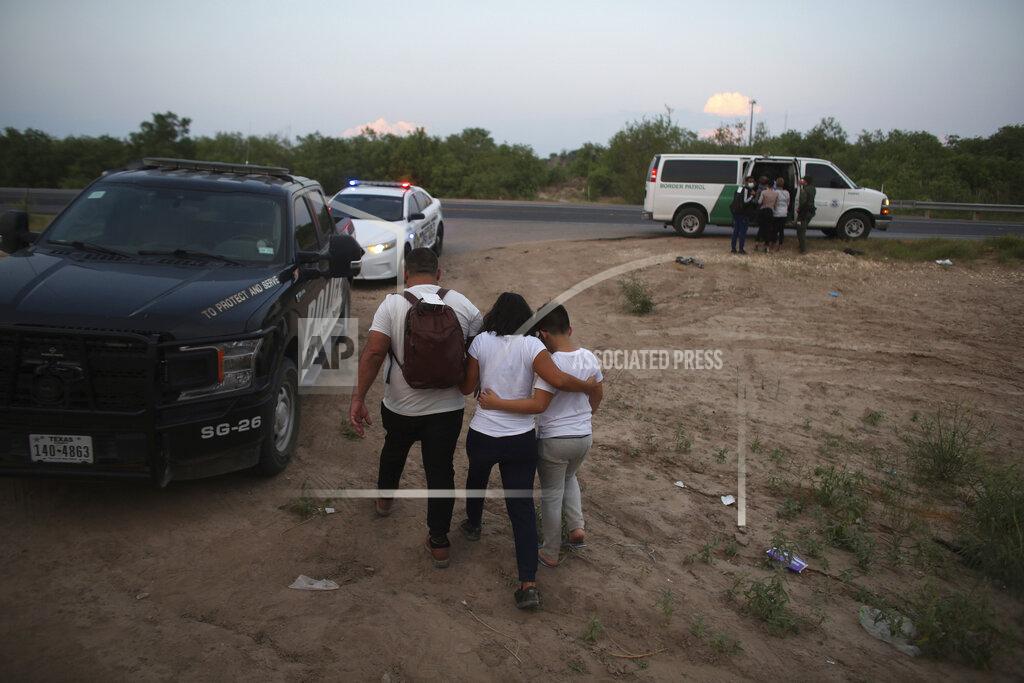 Dario Lopez-Mills A migrant family who earlier crossed the Rio Grande river into the United States is taken away by Border Patrol agents in Eagle Pass, Texas, Saturday, May 21, 2022. The Eagle Pass area has become increasingly a popular crossing corridor for migrants, especially those from outside Mexico and Central America, under Title 42 authority, which expels migrants without a chance to seek asylum on grounds of preventing the spread of COVID-19. (AP Photo/Dario Lopez-Mills)