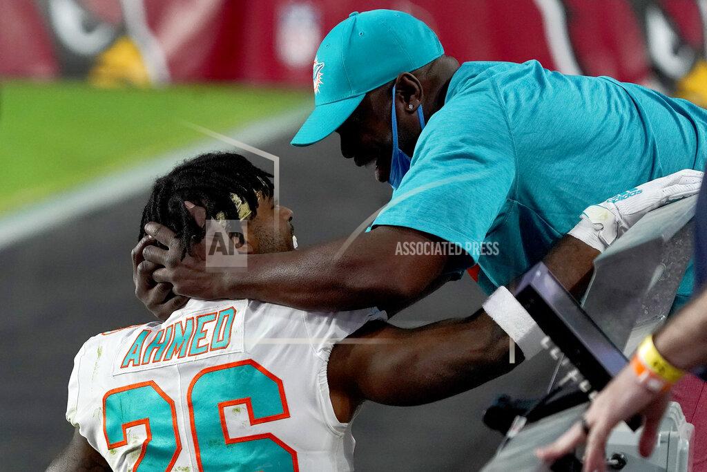 Rick Scuteri Miami Dolphins running back Salvon Ahmed hugs his dad, Randy Ahmed after an NFL football game against the Arizona Cardinals, Sunday, Nov. 8, 2020, in Glendale, Ariz. The Dolphins won 34-31. (AP Photo/Rick Scuteri)