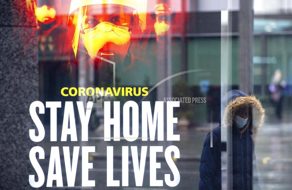 Dominic Lipinski A woman passes a government conronavirus advert in central London, during England's third national lockdown to curb the spread of coronavirus, Thursday, Jan. 14, 2021. (Dominic Lipinski/PA via AP)