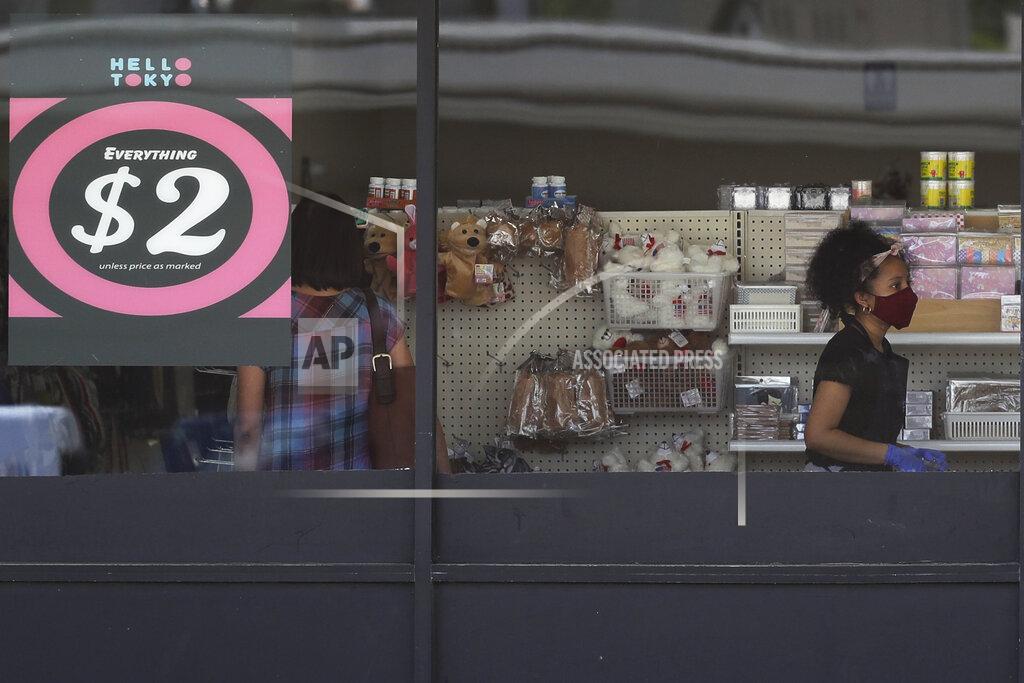 Nam Y. Huh FILE - In this June 25, 2020 file photo, a price sign is displayed at a retail store as a store employee wears a mask while working in Niles, Ill. Small businesses are in limbo again as the coronavirus outbreak rages and the government’s $659 billion relief program draws to a close. Companies still struggling with sharply reduced revenue are wondering if Congress will give them a second chance at the Paycheck Protection Program, which ends Friday, Aug. 7, after giving out 5.1 million loans worth $523 billion. (AP Photo/Nam Y. Huh, File)