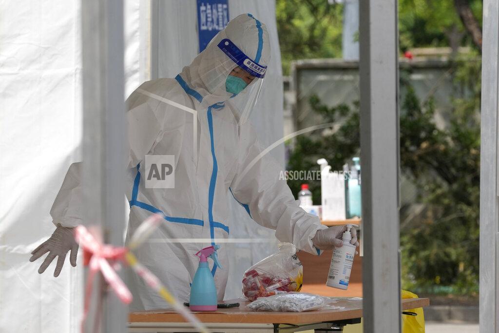 Ng Han Guan A worker collects a bag of samples for mass COVID test on Monday, May 23, 2022, in Beijing. (AP Photo/Ng Han Guan)