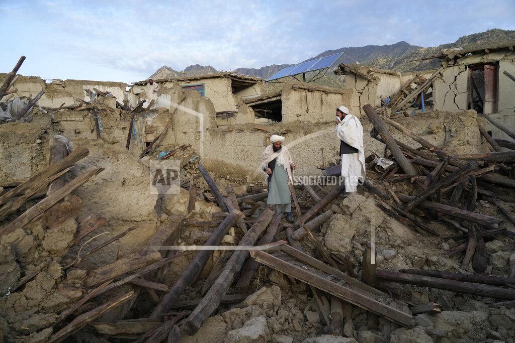 Ebrahim Noroozi Afghans stand among destruction after an earthquake in Gayan village, in Paktika province, Afghanistan, Thursday, June 23, 2022. A powerful earthquake struck a rugged, mountainous region of eastern Afghanistan early Wednesday, flattening stone and mud-brick homes in the country's deadliest quake in two decades, the state-run news agency reported. (AP Photo/Ebrahim Nooroozi)