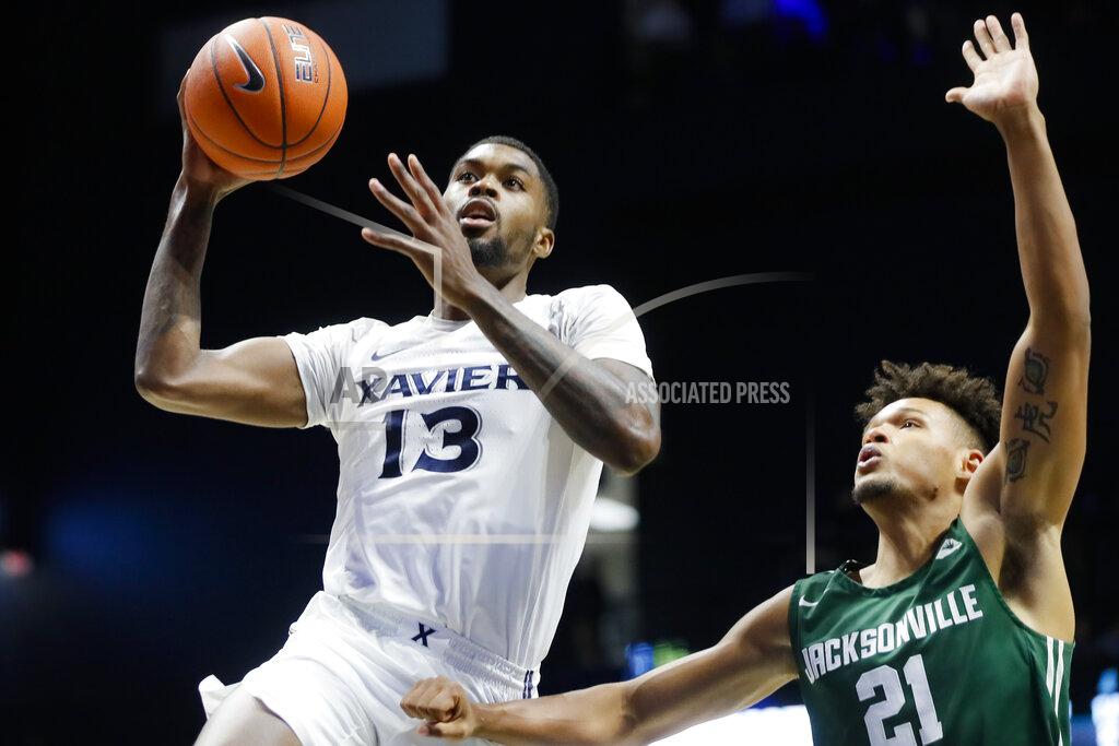 John Minchillo Xavier's Naji Marshall (13) shoots against Jacksonville's Derrick Flowers (21) during the second half of an NCAA college basketball game Tuesday, Nov. 5, 2019, in Cincinnati. (AP Photo/John Minchillo)