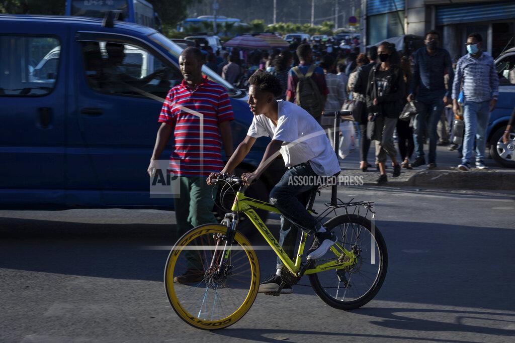 Mulugeta Ayene An Ethiopian rides his bicycle on a street in the capital Addis Ababa, Ethiopia Thursday, Nov. 5, 2020. Ethiopia's powerful Tigray region asserts that fighter jets have bombed locations around its capital, Mekele, aiming to force the region "into submission," while Ethiopia's army says it has been forced into an "unexpected and aimless war." (AP Photo/Mulugeta Ayene)