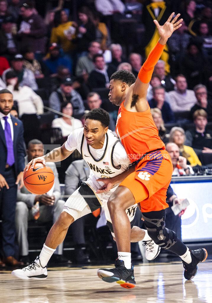 Andrew Dye Wake Forest guard Brandon Childress (0) drives as Clemson guard Clyde Trapp defends during an NCAA college basketball game Saturday, Feb. 1, 2020, in Winston-Salem, N.C. (Andrew Dye/The Winston-Salem Journal via AP)