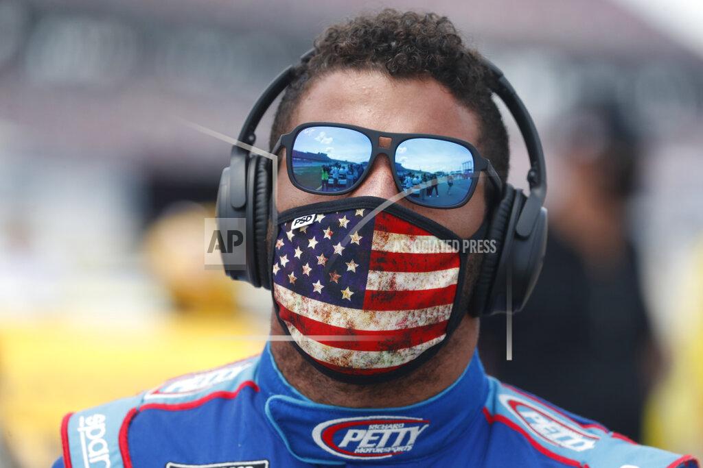 John Bazemore Driver Bubba Wallace walks to his car in the pits of the Talladega Superspeedway prior to the start of the NASCAR Cup Series auto race at the Talladega Superspeedway in Talladega Ala., Monday June 22, 2020. In an extraordinary act of solidarity with NASCAR’s only Black driver, dozens of drivers pushed the car belonging to Bubba Wallace to the front of the field before Monday’s race as FBI agents nearby tried to find out who left a noose in his garage stall over the weekend. (AP Photo/John Bazemore)