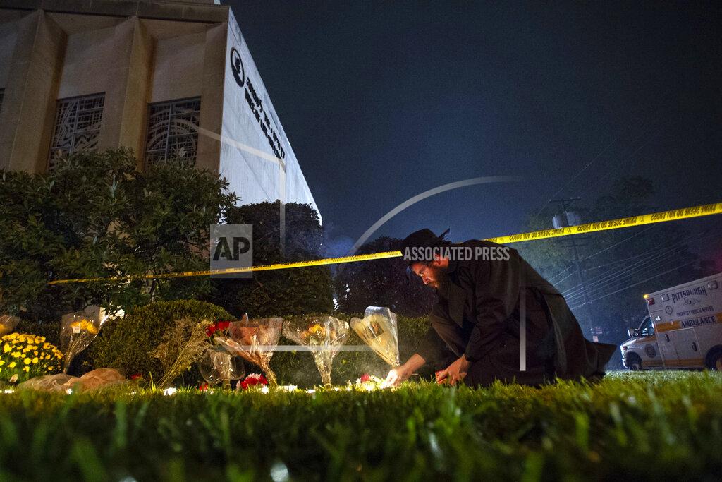 Steph Chambers FILE - In this Oct. 27, 2018 photo, Rabbi Eli Wilansky lights a candle after a mass shooting at Tree of Life Synagogue in Pittsburgh's Squirrel Hill neighborhood. The three congregations sharing space at the Tree of Life synagogue relocated after an anti-Semitic gunman killed 11 worshippers. In March 2020, the congregations dispersed from their new locations due to the coronavirus pandemic and switched to virtual services. (Steph Chamber/Pittsburgh Post-Gazette via AP)