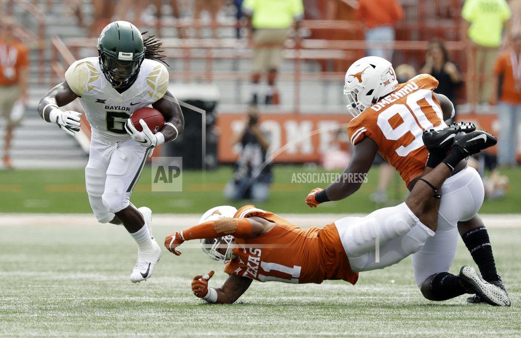 Eric Gay Baylor running back JaMycal Hasty (6) runs past the grasp of Texas defensive back P.J. Locke III (11) during the first half of an NCAA college football game, Saturday, Oct. 13, 2018, in Austin, Texas. (AP Photo/Eric Gay)