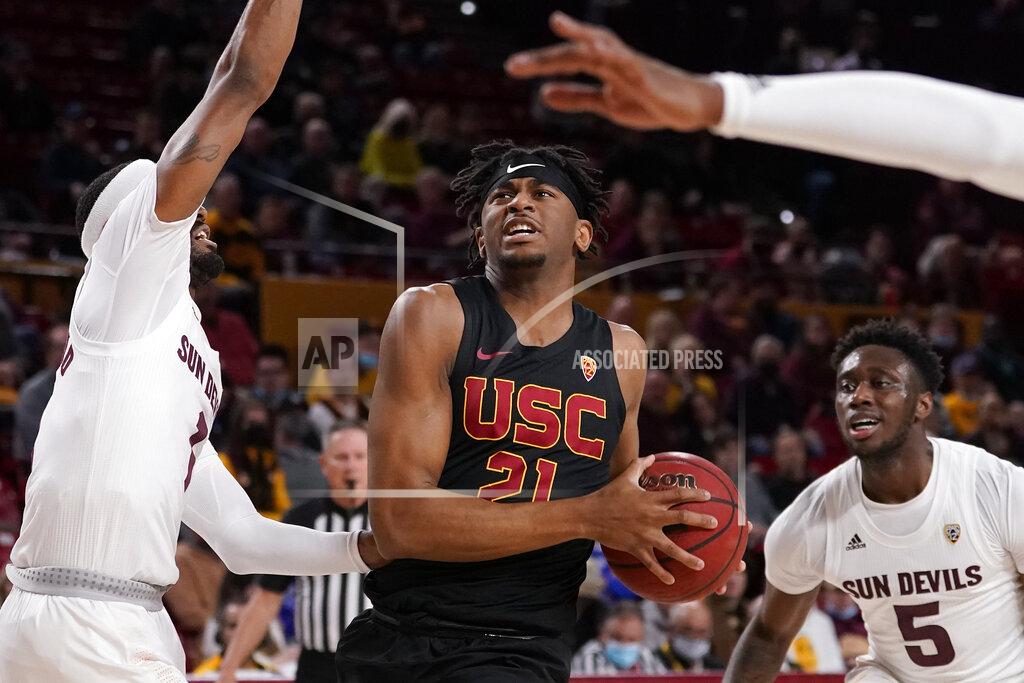 Matt York CORRECTS LOCATION TO TEMPE, INSTEAD OF PHOENIX - Southern California guard Reese Dixon-Waters (21) drives against Arizona State during the first half of an NCAA college basketball game, Thursday, Feb. 3, 2022, in Tempe, Ariz. (AP Photo/Matt York)
