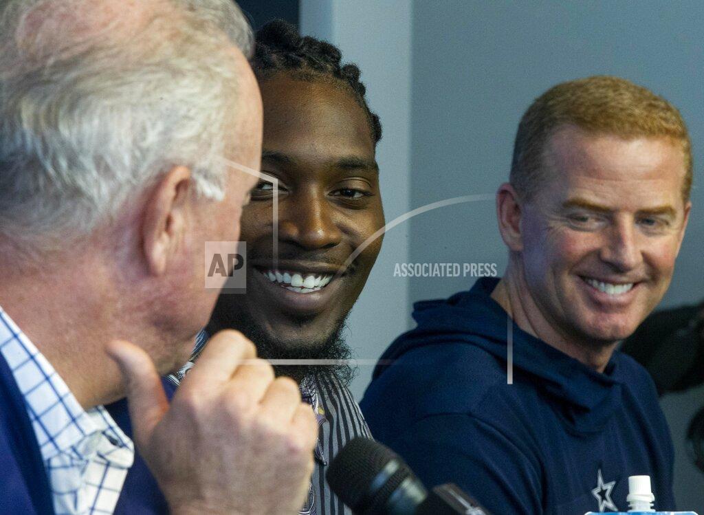 Dallas Cowboys defensive end Demarcus Lawrence, center, laughs along with CEO Stephen Jones and head coach Jason Garrett during a press conference at The Star in Frisco, Texas, Tuesday, April 9, 2019. DeMarcus Lawrence may not be the highest-paid Dallas Cowboys player in history for long. It doesn’t mean the club’s best defensive end can’t enjoy the distinction while it lasts. The 26-year-old Lawrence signed a $105 million, five-year contract Tuesday.(Shaban Athuman/The Dallas Morning News via AP)