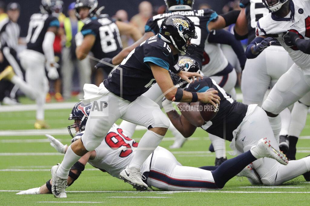 David J. Phillip Jacksonville Jaguars quarterback Gardner Minshew (15) scramble past Houston Texans defensive end J.J. Watt (99) during the second half of an NFL football game Sunday, Sept. 15, 2019, in Houston. (AP Photo/David J. Phillip)