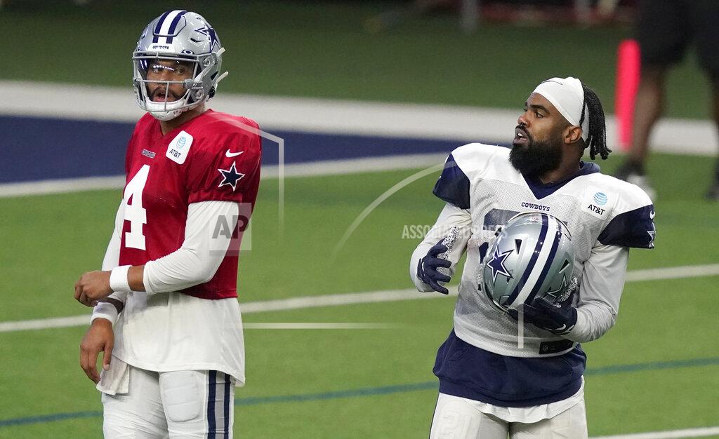 Dallas Cowboys quarterback Dak Prescott (4) and running back Ezekiel Elliott (21) start to line up for a drill during an NFL football training camp in Frisco, Texas, Monday, Aug. 17, 2020. (AP Photo/LM Otero)