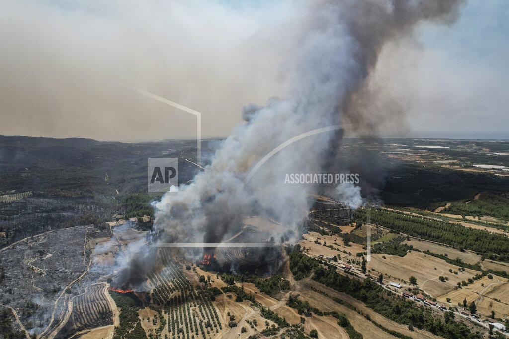 Uncredited An aerial photo shows wildfires in Kacarlar village near the Mediterranean coastal town of Manavgat, Antalya, Turkey, Saturday, July 31, 2021. The death toll from wildfires raging in Turkey's Mediterranean towns rose to six Saturday after two forest workers were killed, the country's health minister said. Fires across Turkey since Wednesday burned down forests, encroaching on villages and tourist destinations and forcing people to evacuate. (AP Photo)