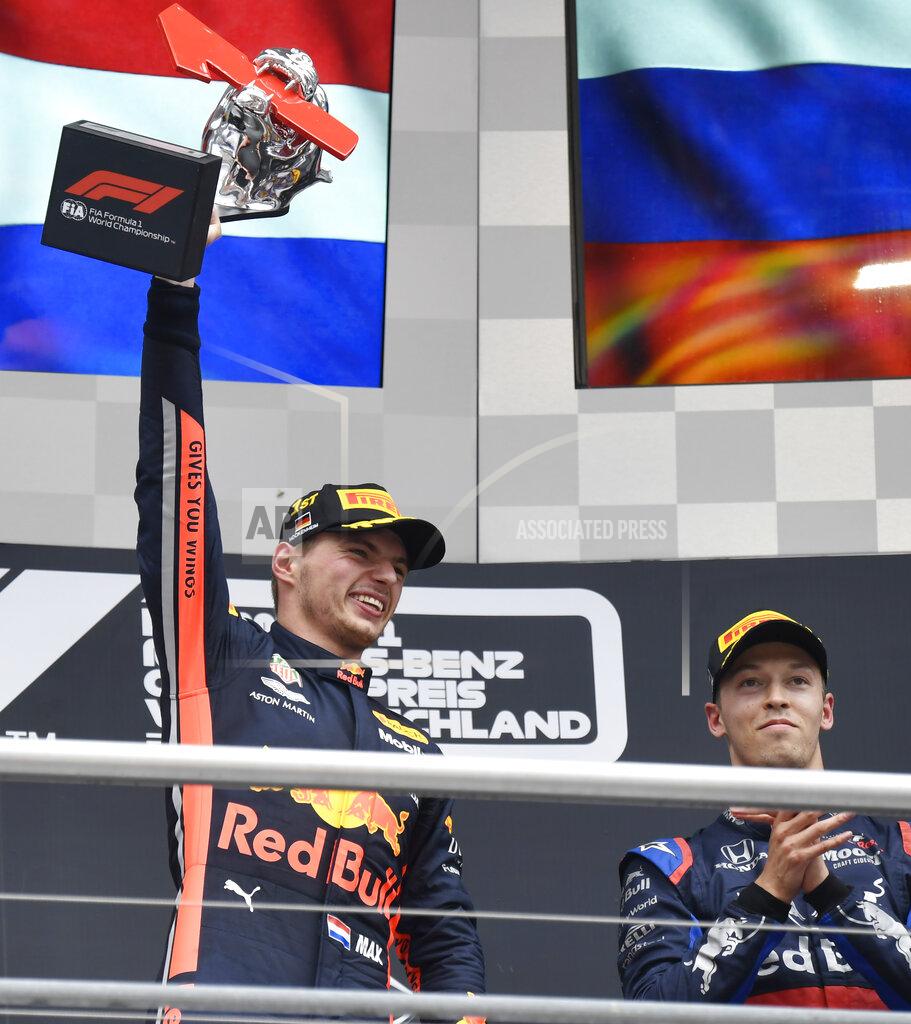 Jens Meyer Red Bull driver Max Verstappen of the Netherland's, left, celebrates on the podium after he won the German Formula One Grand Prix at the Hockenheimring racetrack in Hockenheim, Germany, Sunday, July 28, 2019. On the right is third place Toro Rosso driver Daniil Kvyat of Russia. (AP Photo/Jens Meyer)