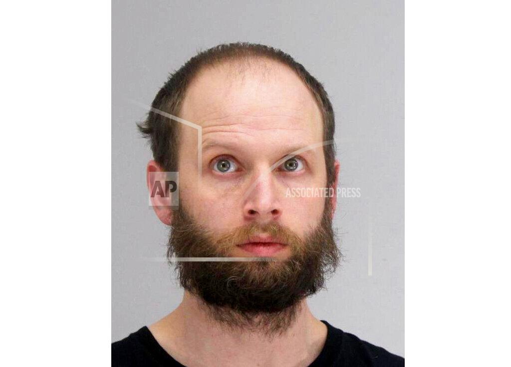 Uncredited This photo provided by the Dallas County Sheriff's Office shows Garrett Miller. Miller has been arrested for allegedly taking part in the storming of the U.S. Capitol this month and posting violent threats, including a call to assassinate Democratic Rep. Alexandria Ocasio-Cortez of New York. Garret Miller, who is from the Dallas suburb of Richardson, was arrested Friday, Jan. 22, 2021 after being named in a five-count federal complaint. (Dallas County Sheriff's Office via AP)