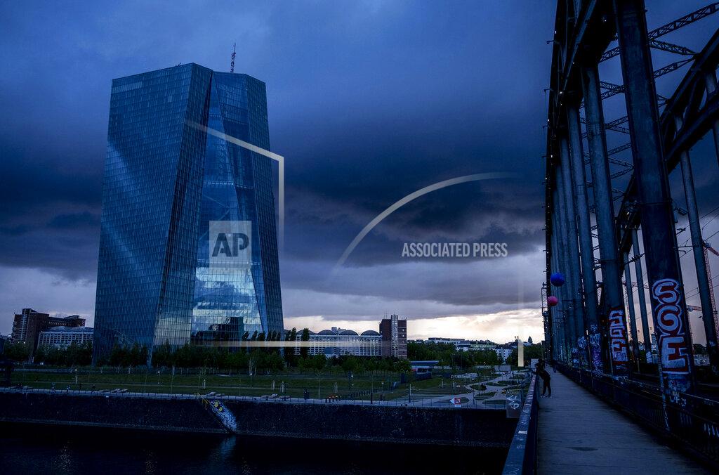 FILE - In this file photo dated Friday, May 1, 2020, the European Central Bank is shadowed by heavy clouds in Frankfurt, Germany. The central bank for the 19 countries that use the euro said Thursday June 18, 2020, That it has handed out more than a trillion euros in cheap loans to banks as part of its effort to get the economy through the virus outbreak. (AP Photo/Michael Probst, FILE)