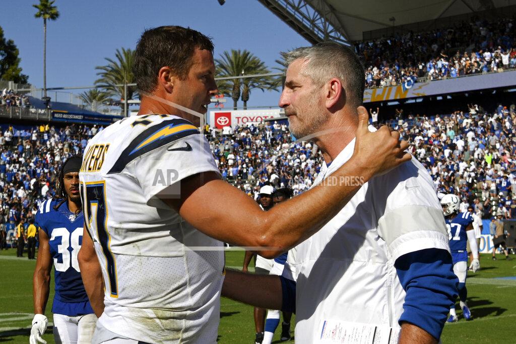 Mark J. Terrill FILE - In this Sept. 8, 2019, file photo, Los Angeles Chargers quarterback Philip Rivers, left, greets Indianapolis Colts head coach Frank Reich after an NFL football game in Carson, Calif. The Indianapolis Colts bet big on 38-year-old Philip Rivers. They're hoping the $25 million investment in a new starting quarterback pays off with a playoff appearance and perhaps Super Bowl run. Colts coach Frank Reich insists he's seen no physical decline in the eight-time Pro Bowler. (AP Photo/Mark J. Terrill, File)