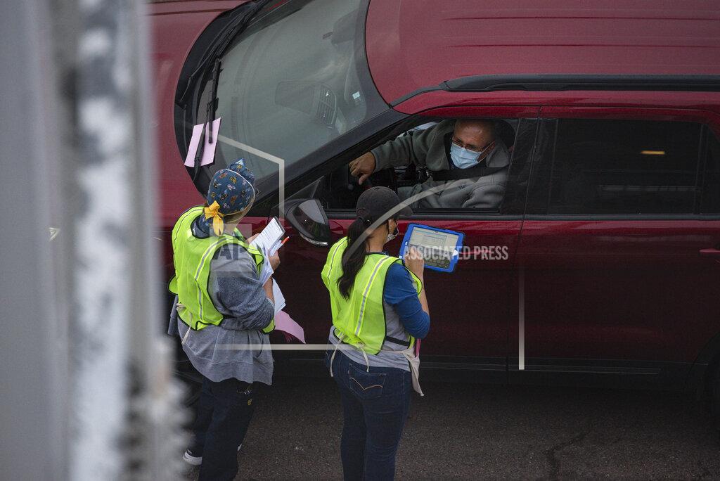 Eli Hartman Volunteers take down information as they register people to receive the Pfizer COVID-19 vaccine at the vaccination clinic put on by the City of Odessa, Odessa Fire Rescue and Medical Center Hospital Sunday, Jan. 24, 2021 at Ratliff Stadium in Odessa, Texas. (Eli Hartman/Odessa American via AP)