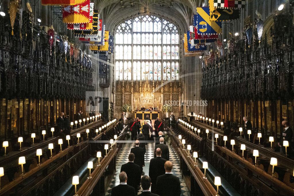 Barnaby Fowler Princess Anne, Prince Charles, Prince Edward, Prince Andrew, Peter Phillips, Prince William, the Earl of Snowdon, Prince Harry and Tim Laurence, follow as the coffin is brought in Britain Prince Philip's funeral at St George's chapel in Windsor Castle, Windsor, England, Saturday April 17, 2021. Prince Philip died April 9 at the age of 99 after 73 years of marriage to Britain's Queen Elizabeth II. (Barnaby Fowler/Pool via AP)