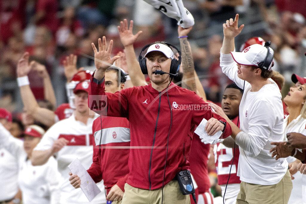 Jeffrey Mcwhorter FILE - In this Saturday, Dec. 7, 2019, file photo, Oklahoma head coach Lincoln Riley cheers with his players and coaches during the first half of an NCAA college football game against Baylor for the Big 12 Conference championship, in Arlington, Texas. Riley already has coached Heisman Trophy winners Baker Mayfield and Kyler Murray along with Heisman runner-up Jalen Hurts. Now, he is hoping to build a new tradition at Oklahoma - pulling top quarterbacks to Oklahoma from the high school ranks. Caleb Williams, the No. 1 quarterback in the 247Sports Class of 2021 and ESPN’s No. 1 dual-threat quarterback for that class, has committed to Oklahoma. (AP Photo/Jeffrey McWhorter, File)