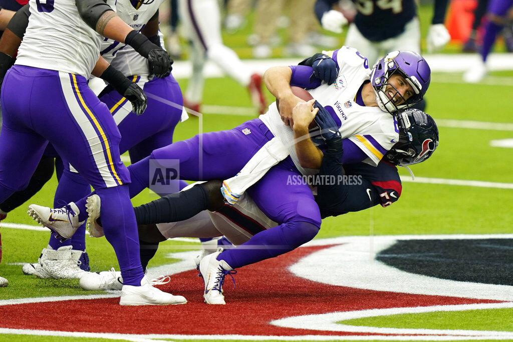 David J. Phillip Minnesota Vikings quarterback Kirk Cousins (8) is sacked by Houston Texans outside linebacker Whitney Mercilus (59) during an NFL football game Sunday, Oct. 4, 2020, in Houston. (AP Photo/David J. Phillip)