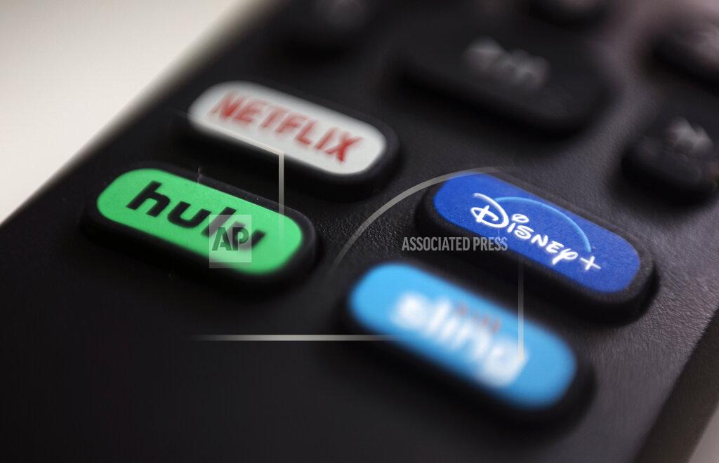 Jenny Kane FILE - In this Aug. 13, 2020 file photo, the logos for Netflix, Hulu, Disney Plus and Sling TV are pictured on a remote control in Portland, Ore. As movie theaters closed and lockdowns descended across the country, people turned to the ever-growing number of video streaming services for entertainment. (AP Photo/Jenny Kane)