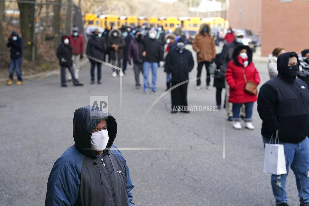 Seth Wenig People wait in line for the COVID-19 vaccine in Paterson, N.J., Thursday, Jan. 21, 2021. Some hospitals around the U.S. are facing complaints about favoritism and line-jumping after their board members and donors received COVID-19 vaccinations or offers for the prized inoculations. (AP Photo/Seth Wenig)