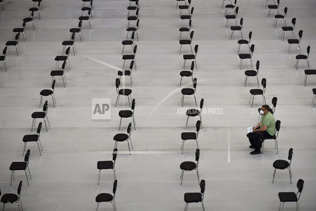 Alvaro Barrientos A man waits after receiving the Pfizer vaccine, during a COVID-19 vaccination campaign, in Pamplona, northern Spain, Tuesday, May 11, 2021. (AP Photo/Alvaro Barrientos)