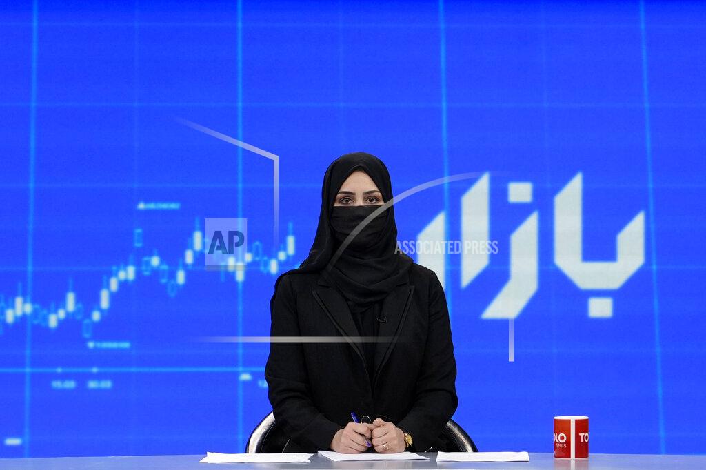 Ebrahim Noroozi TV anchor Khatereh Ahmadi wears a face covering as she reads the news on TOLO NEWS, in Kabul, Afghanistan, Sunday, May 22, 2022. Afghanistan's Taliban rulers have begun enforcing an order requiring all female TV news anchors in the country to cover their faces while on-air. The move Sunday is part of a hard-line shift drawing condemnation from rights activists. (AP Photo/Ebrahim Noroozi)