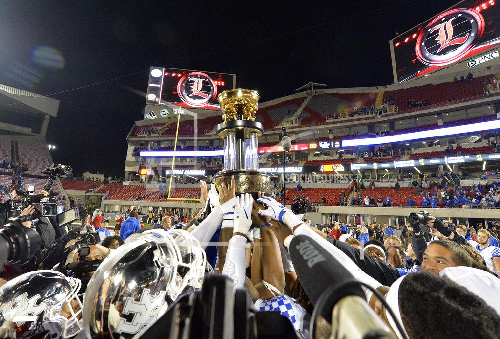 Timothy D. Easley Kentucky football players hold up the Governor's Cup following their 56-10 victory over Louisville in an NCAA college football game, in Louisville, Ky., Saturday, Nov. 24, 2018. (AP Photo/Timothy D. Easley)