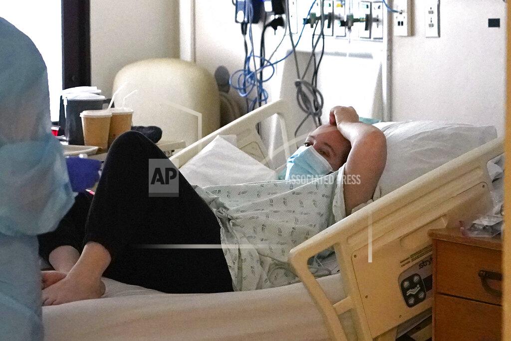 Elaine Thompson Coronavirus patient Shanon Walker looks up from her hospital bed in the COVID acute care unit at UW Medical Center-Montlake, Tuesday, Jan. 26, 2021, in Seattle. King County, where the hospital is located, has been on a downward trend of COVID-19 cases after two-and-a-half straight months of increases. But the current lull could be, and some experts believe will be, upended as more contagious variants of the virus spread throughout United States. (AP Photo/Elaine Thompson)