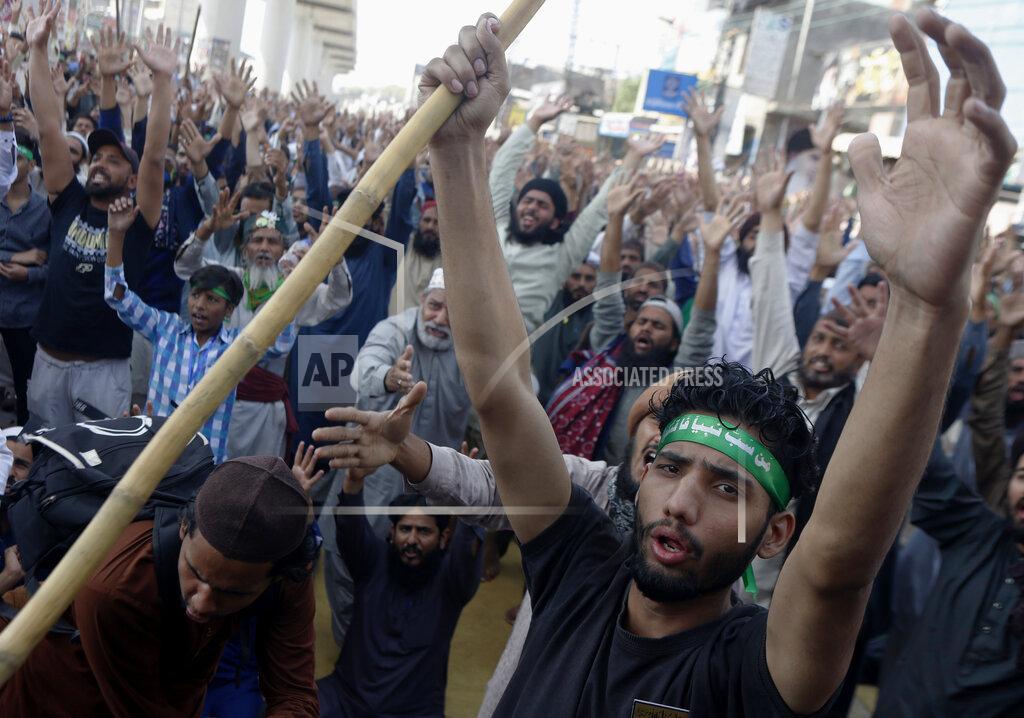 K.M. Chaudary Supporters of Tehreek-e-Labiak Pakistan, a banned Islamist party, chant slogans during a protest on the arrest of their party leader Saad Rizvi, who was demanding the government to expel French ambassador, in Lahore, Pakistan, Monday, April 19, 2021. The outlawed Pakistani Islamist political group freed 11 policemen almost a day after taking them hostage in the eastern city of Lahore amid violent clashes with security forces, the country's interior minister said Monday. (AP Photo/K.M. Chaudary)
