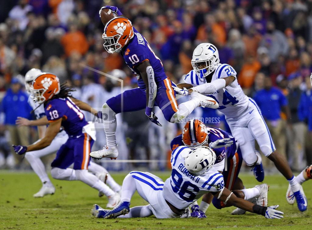 Richard Shiro FILE - In this Nov. 17, 2018, file photo, Clemson's Derion Kendrick (10) hurdles Duke's Chris Rumph ll (96) on a kickoff return as Jarrett Garner reaches for him during the first half of an NCAA college football game in Clemson, S.C. Kickoff returns are down about 20 percent in the first year of a new NCAA rule that gives the receiving team possession at its 25-yard line if the kick is fair caught anywhere between the goal line and 25. (AP Photo/Richard Shiro, File)