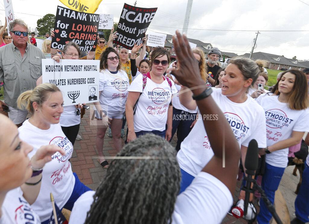 Yi-Chin Lee FILE - In this June 7, 2021, file photo, people gather in Baytown, Texas, to protest Houston Methodist Hospital system’s policy that says hospital employees must get vaccinated against COVID-19 or lose their jobs. A federal judge dismissed their lawsuit, saying if workers don’t like the rule, they can go find another job. (Yi-Chin Lee/Houston Chronicle via AP)