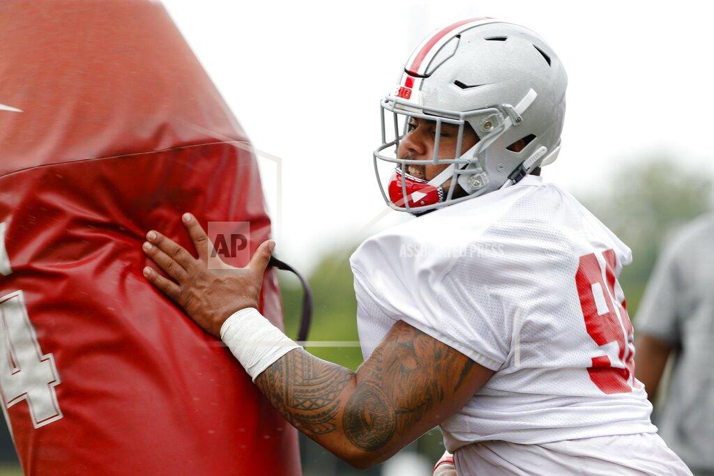 Joshua A. Bickel Ohio State Buckeyes defensive tackle Haskell Garrett runs a drill during Ohio State Buckeyes football practice on Wednesday, Aug. 14, 2019, at the Woody Hayes Athletic Center in Columbus, Ohio. Garrett is expected to be released from the hospital after being shot in the face over the weekend, coach Ryan Day said. Day said in a statement that Garrett, who was hit by a bullet that passed through both of his cheeks, was expected to be released Monday. (Joshua A. Bickel/The Columbus Dispatch via AP)
