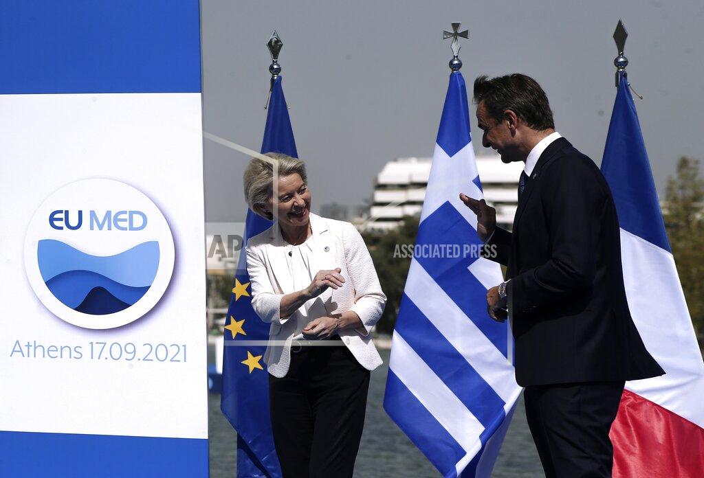 Panayotis Tzamaros Greek Prime Minister Kyriakos Mitsotakis, right, welcomes the European Commission President Ursula von der Leyen during the EUMED 9 summit at the Stavros Niarchos Foundation Cultural Center in Athens, Friday, Sept. 17, 2021. Nine European countries on the Mediterranean are holding a summit in Athens to discuss issues ranging from climate change and the pandemic response to migration and Afghanistan. (Panayotis Tzamaros/InTime News via AP)