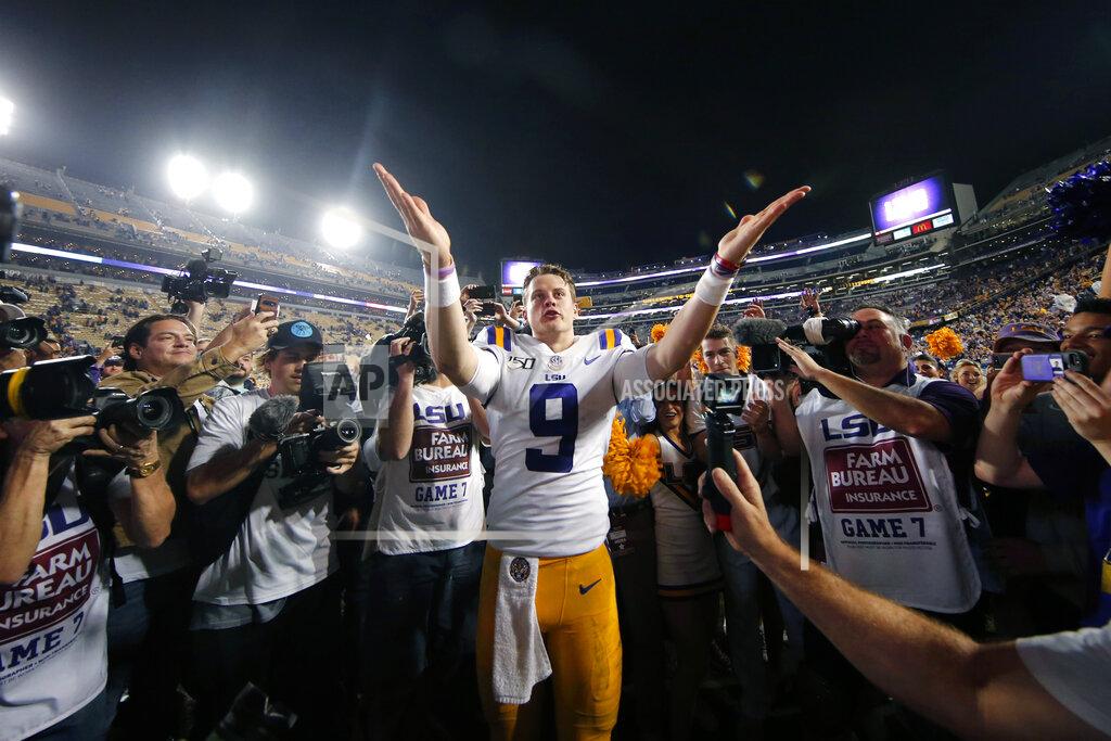 Gerald Herbert FILE - In this Nov. 30, 2019, file photo, LSU quarterback Joe Burrow (9) gestures thanks to the student section after playing his last game in Tiger Stadium, an NCAA college football game against Texas A&M, in Baton Rouge, La. Heading into this year’s slate of conference title games a case could be made that No. 1 LSU (No. 2 CFP), No. 2 Ohio State (No. 1 CFP) and No. 3 Clemson (No. 3 CFP) have all done enough already to lose their conference championship games and still get in the College Football Playoff. (AP Photo/Gerald Herbert, File)