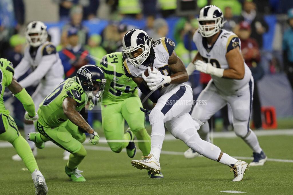 Stephen Brashear Los Angeles Rams running back Todd Gurley, second from right, rushes for a touchdown against the Seattle Seahawks during the second half of an NFL football game Thursday, Oct. 3, 2019, in Seattle. (AP Photo/Stephen Brashear)