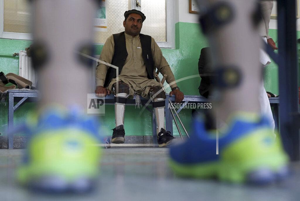 Rahmat Gul Afghan polio patient Maiwa Gul waits to have his orthopedic devices checked at the International Committee of the Red Cross’ Orthopedic Program, in Kabul, Afghanistan, Monday, March 29, 2021. In 2020, nearly 5,000 polio patients received treatment at the program, including physiotherapy, medical equipment and orthopedic devices. (AP Photo/Rahmat Gul)