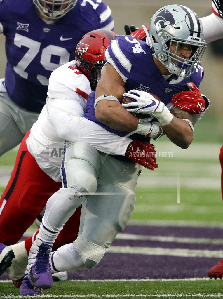 Orlin Wagner Kansas State running back Alex Barnes (34) is tackled by Texas Tech defensive lineman Joseph Wallace (97) during the first half of an NCAA college football game in Manhattan, Kan., Saturday, Nov. 17, 2018. (AP Photo/Orlin Wagner)