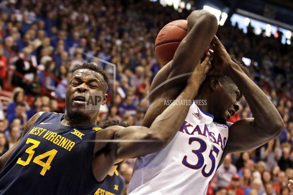 Charlie Riedel West Virginia's Oscar Tshiebwe (34) steals the ball from Kansas' Udoka Azubuike (35) during the first half of an NCAA college basketball game Saturday, Jan. 4, 2020, in Lawrence, Kan. (AP Photo/Charlie Riedel)